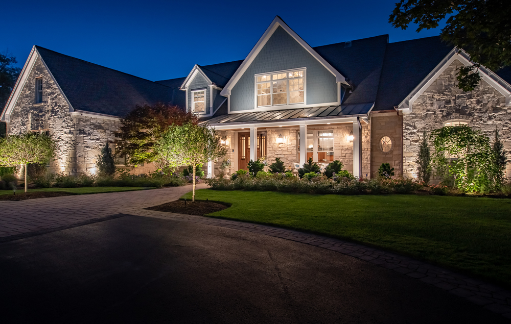 Stone façade exterior home lighting by Outdoor Lighting Perspectives